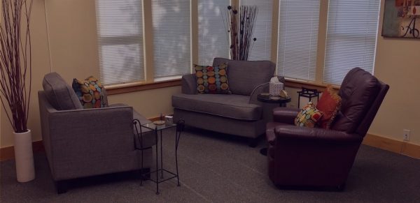 Marlo Bennett's office with three couches, a bay window and painting