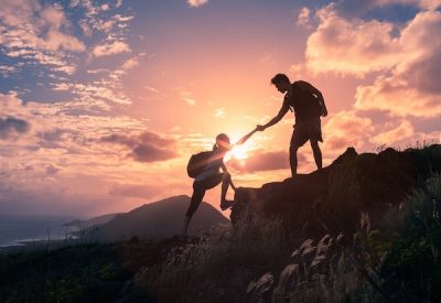 Hikers helping each other