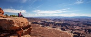 hiker sitting at canyon's edge