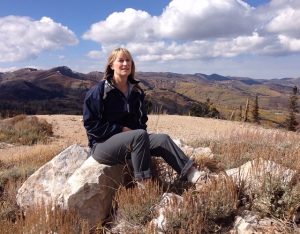 Marlo Bennet on a hike, sitting on a rock