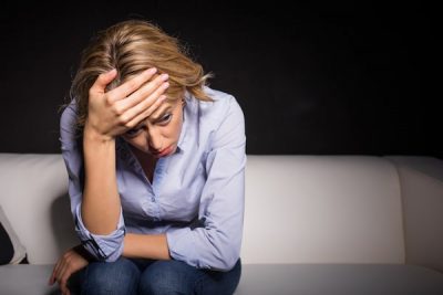 stressed woman holding her head