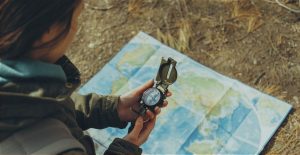 Female traveler with a compass and map