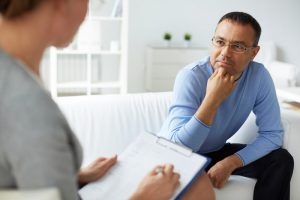 male patient listening to psychologist