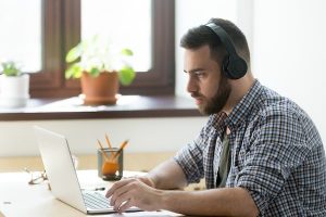 male employee watching training video on laptop