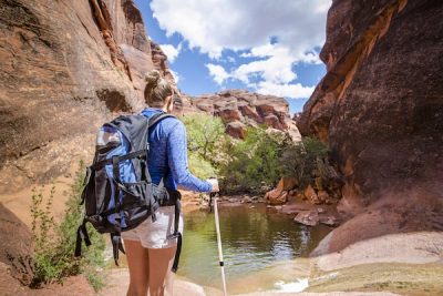 woman hiking to pond in red rock canyon