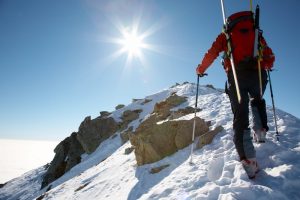 climber summiting snowy peak
