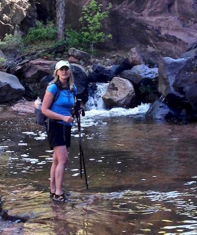 Marlo Bennett hiking through creek